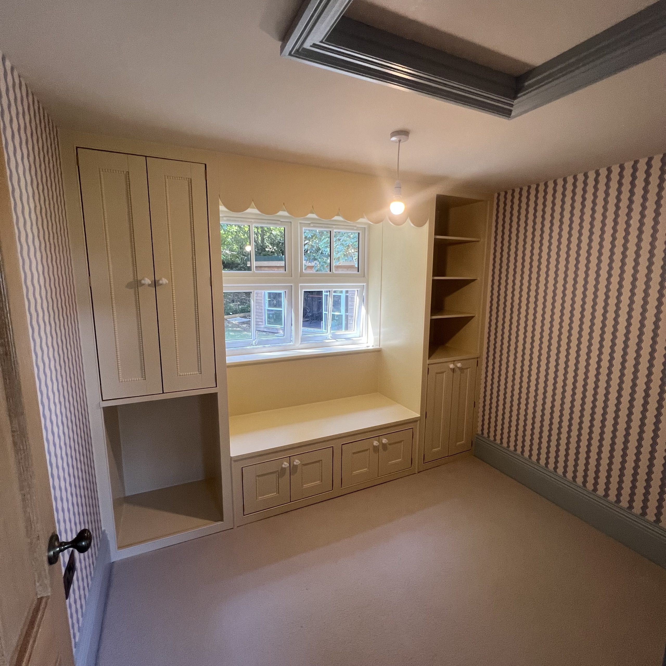 Custom built wardrobes painted inside and out. Skirts and wallpaper painted blue and wallpaper hung.